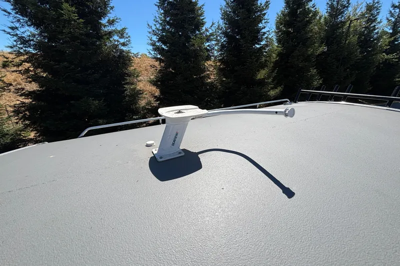 Slide: The Image of Rooftop antenna on 2025 Spartan 2600 Olympia RV, surrounded by trees. - 39