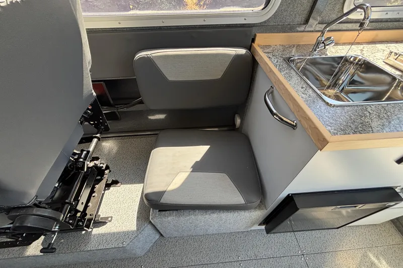 Slide: The Image of Interior of 2025 Spartan 2600 Olympia RV with seating and compact kitchen area. - 49