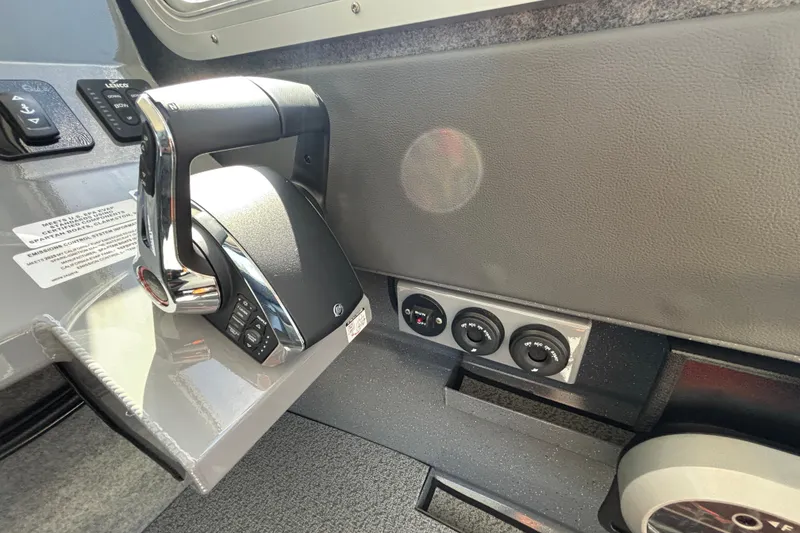 Slide: The Image of Control panel of 2025 Spartan 2600 Olympia boat with throttle and switches. - 59