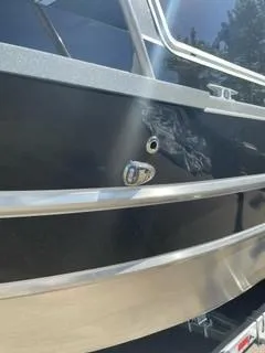 Slide: The Image of 2025 Spartan 2600 Olympia boat with sleek black exterior and metallic accents. - 7