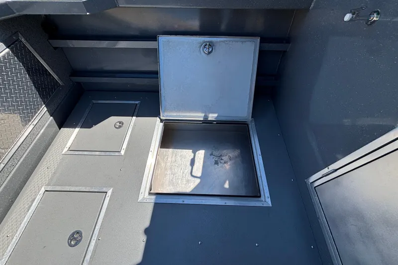 Slide: The Image of 2025 Spartan 2600 Olympia boat storage compartments with open hatch, showcasing interior space. - 58