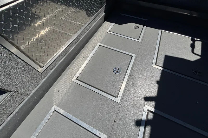 Slide: The Image of Interior of 2025 Spartan 2600 Olympia with diamond plate and storage compartments. - 13