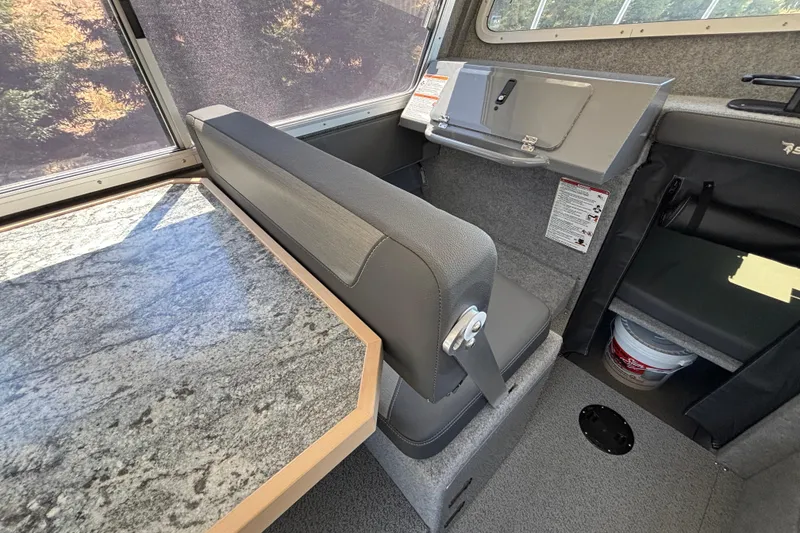 Slide: The Image of Interior of 2025 Spartan 2600 Olympia boat with gray seating and granite-style table. - 29
