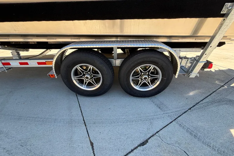 Slide: The Image of Trailer wheels of a 2025 Spartan 2600 Olympia on concrete pavement. - 44