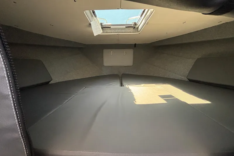 Slide: The Image of Interior cabin of 2025 Spartan 2600 Olympia boat with skylight and cushioned seating. - 62