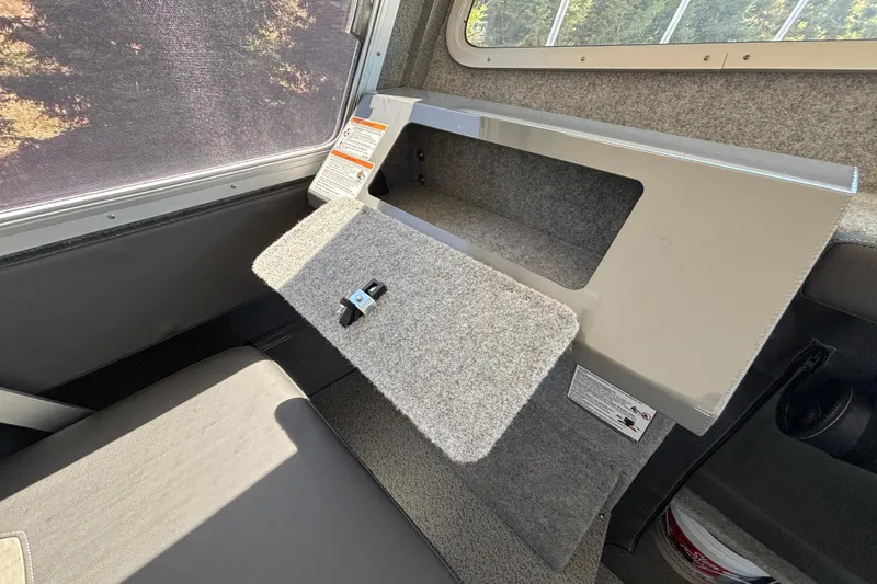 Slide: The Image of Interior of 2025 Spartan 2600 Olympia with open storage compartment and seat. - 47
