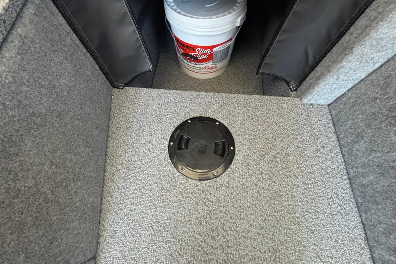 Slide: The Image of Carpeted interior of 2025 Spartan 2600 Olympia with storage compartment and bucket. - 30