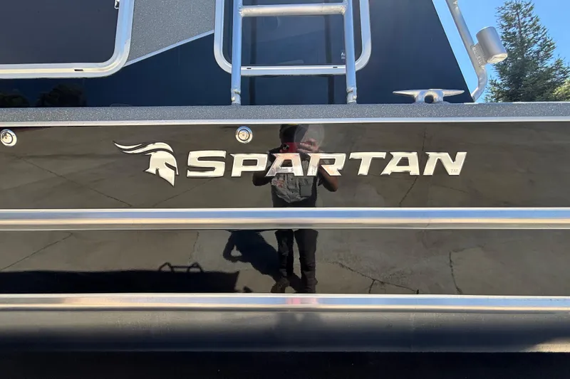 Slide: The Image of 2025 Spartan 2600 Olympia boat with sleek black exterior and reflective logo. - 3