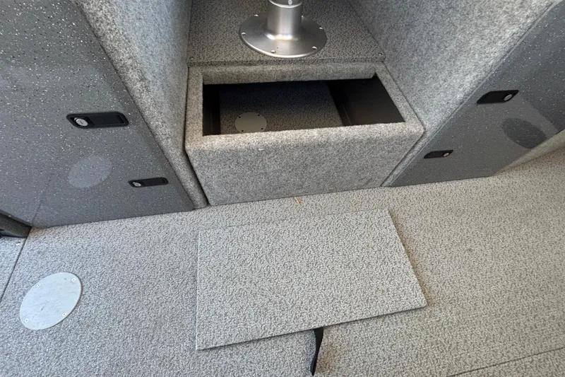 Slide: The Image of Interior storage compartment of 2025 Spartan 2600 Olympia boat, featuring gray textured surfaces. - 26