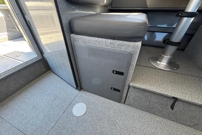 Slide: The Image of Interior of 2025 Spartan 2600 Olympia boat, featuring seating and storage area. - 42