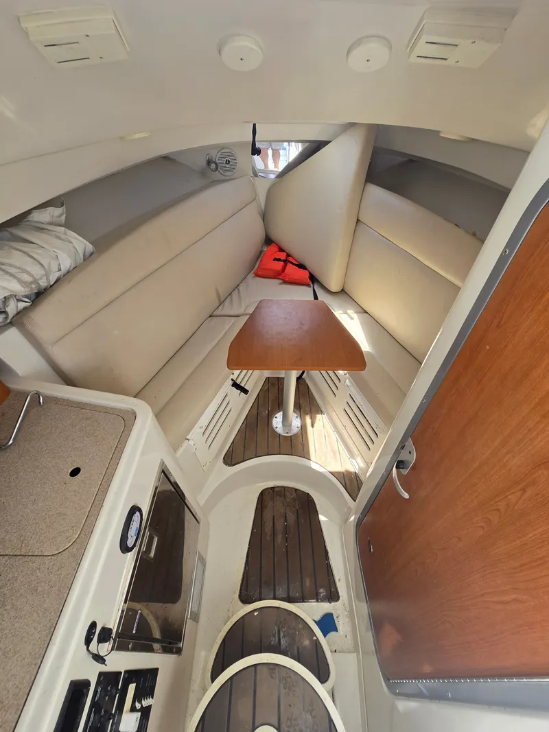 Slide: The Image of Interior of 2015 Sailfish 270 WAC boat with seating and table. - 7