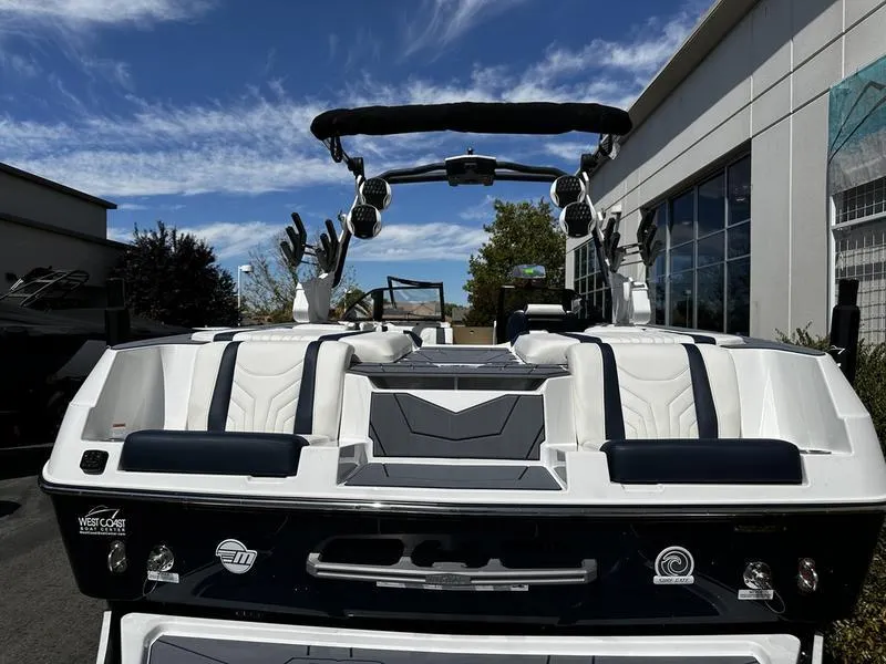 Slide: The Image of 2025 Malibu Wakesetter 25 LSV boat, rear view, sleek design, outdoor setting. - 17