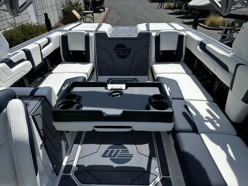 Slide: The Image of 2025 Malibu Wakesetter 25 LSV interior with spacious seating and cup holders. - 18
