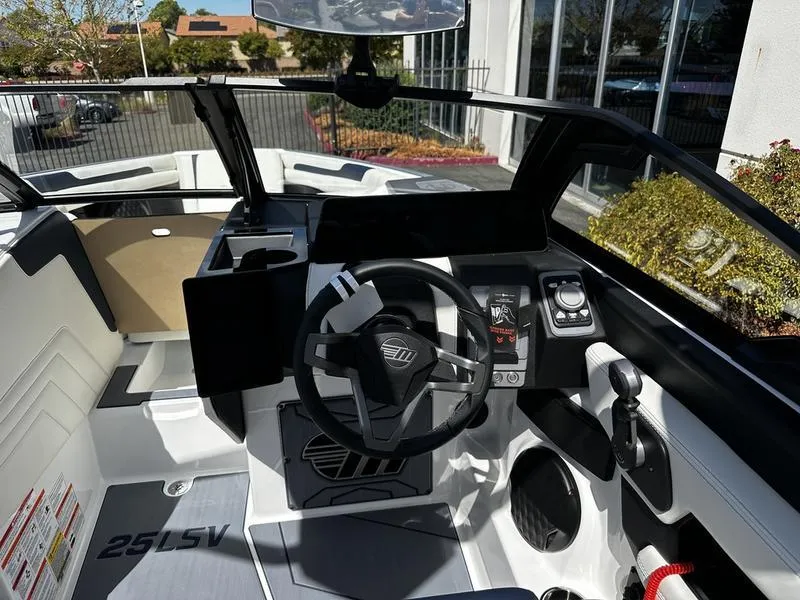 Slide: The Image of 2025 Malibu Wakesetter 25 LSV boat interior with modern dashboard and steering wheel. - 19