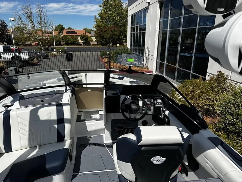Slide: The Image of Interior of 2025 Malibu Wakesetter 25 LSV boat with modern seating and dashboard. - 22