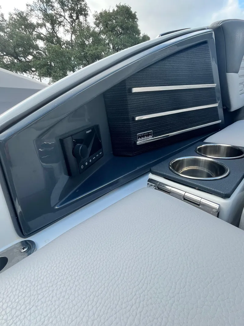 Slide: The Image of 2022 Cobalt A29 boat interior with sleek dashboard and cup holders. - 10