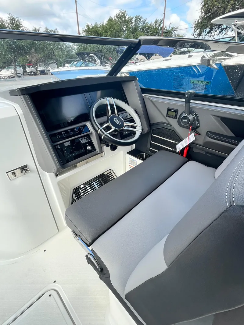 Slide: The Image of 2022 Cobalt A29 boat cockpit with modern steering and dashboard controls. - 14