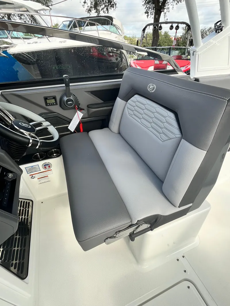 Slide: The Image of 2022 Cobalt A29 boat interior with gray seating and modern dashboard. - 15