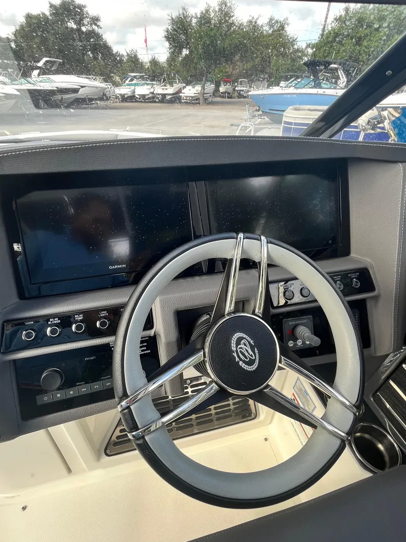 Slide: The Image of 2022 Cobalt A29 boat dashboard with steering wheel and control panel. - 16