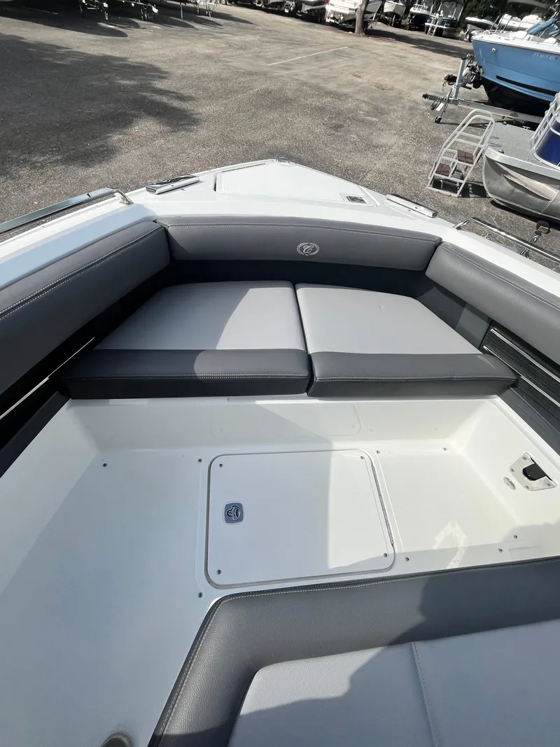 Slide: The Image of 2022 Cobalt A29 boat interior with cushioned seating and storage compartment. - 23