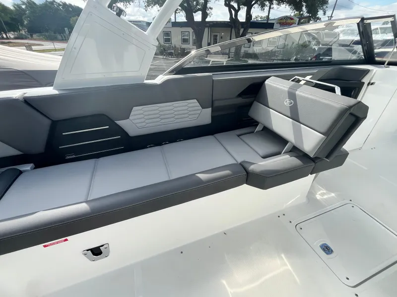 Slide: The Image of 2022 Cobalt A29 boat interior with sleek gray seating and modern design. - 28