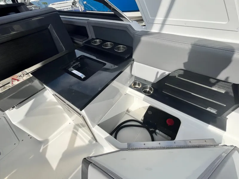 Slide: The Image of 2022 Cobalt A29 boat interior with sleek seating and cup holders. - 30