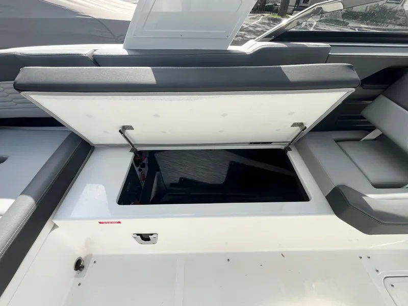 Slide: The Image of 2022 Cobalt A29 boat with open storage compartment, showcasing sleek interior design. - 31