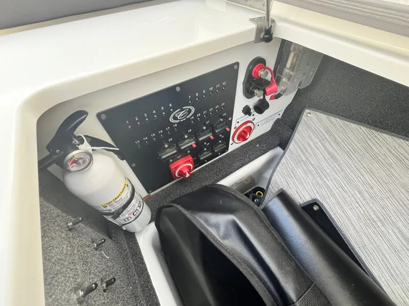 Slide: The Image of 2022 Cobalt A29 boat control panel with fire extinguisher and switches. - 32