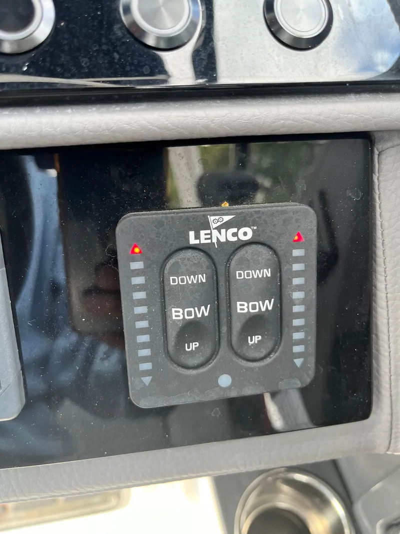 Slide: The Image of Lenco trim tab control panel on 2022 Cobalt A29 boat dashboard. - 35