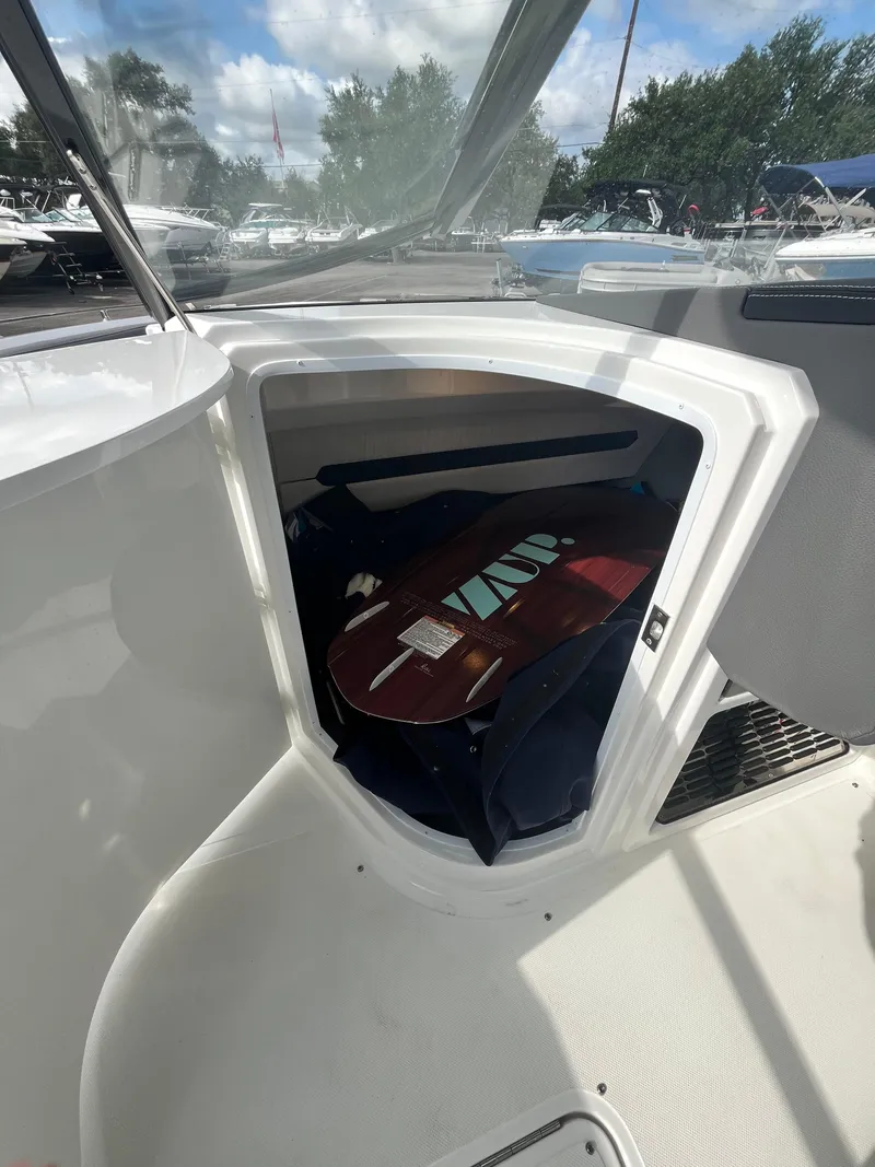 Slide: The Image of 2022 Cobalt A29 boat storage compartment with surfboard inside. - 39