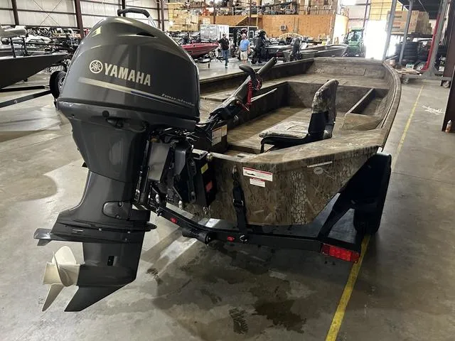 Slide: The Image of 2025 G3 18DK boat with Yamaha 70 engine in warehouse setting. - 4