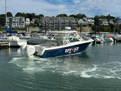 Slide: The Image of 2016 Sailfish 325 DC boat named "OFF ICE" in a marina setting. - 11