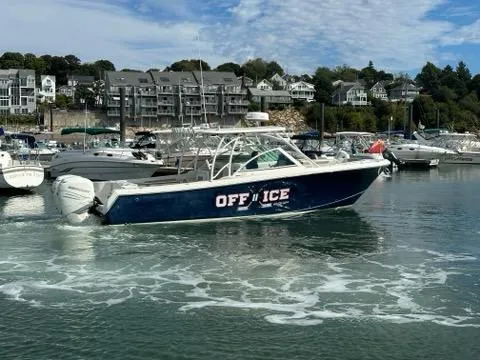 Slide: The Image of 2016 Sailfish 325 DC boat named "OFF ICE" docked in a marina. - 12