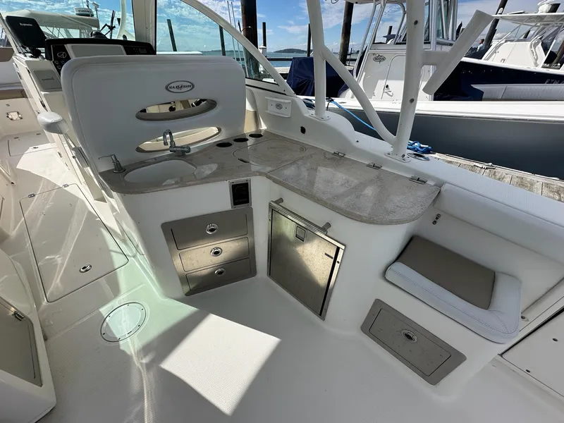 Slide: The Image of 2016 Sailfish 325 DC boat interior with sink, countertop, and storage compartments. - 17