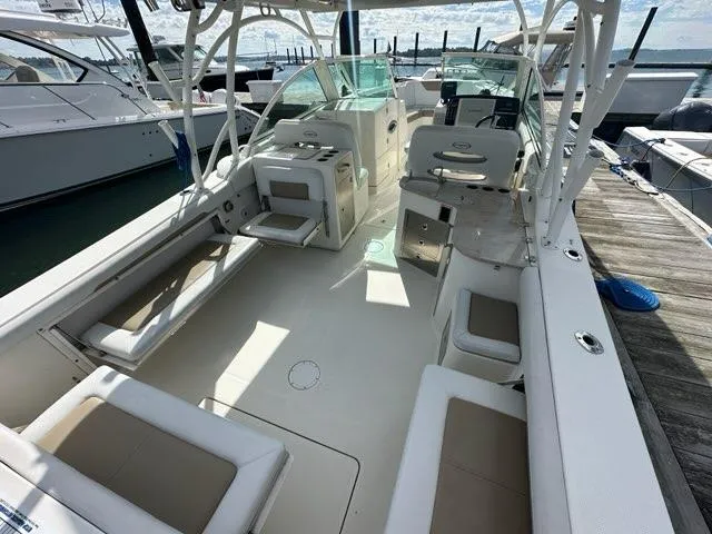 Slide: The Image of 2016 Sailfish 325 DC boat interior with seating and helm, docked at marina. - 25
