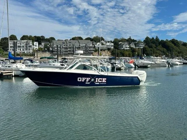 Slide: The Image of 2016 Sailfish 325 DC boat named "OFF ICE" docked in a marina. - 3
