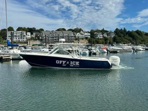 Slide: The Image of 2016 Sailfish 325 DC boat named "OFF ICE" docked in a marina. - 4
