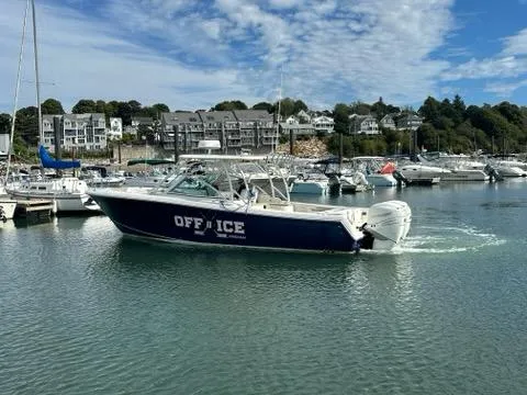 Slide: The Image of 2016 Sailfish 325 DC boat named "OFF ICE" docked in a marina. - 5