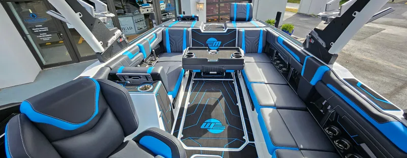 Slide: The Image of Luxurious interior of 2025 Malibu 25LSV boat with blue and black seating. - 14