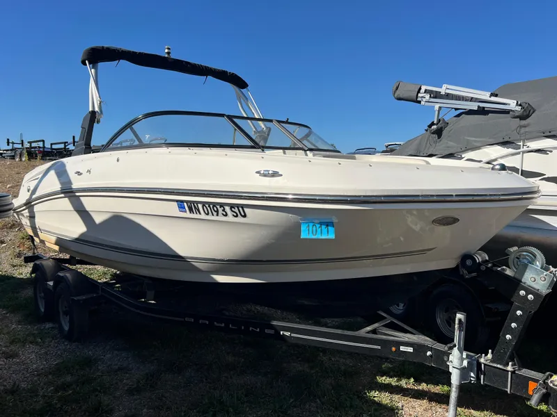 Slide: The Image of 2016 Bayliner VR6 boat on trailer under clear blue sky. - 12