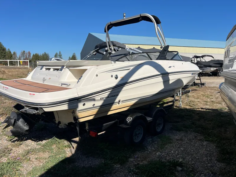 Slide: The Image of 2016 Bayliner VR6 boat on trailer, parked outdoors under clear blue sky. - 14