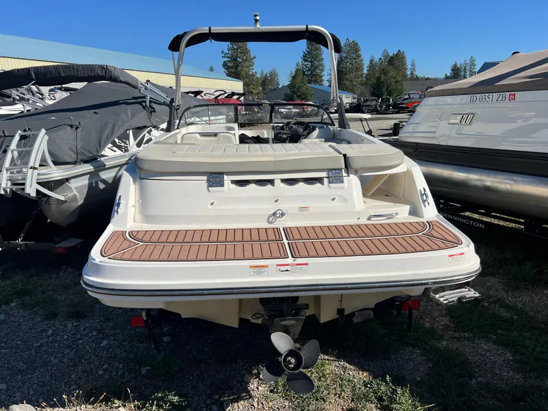 Slide: The Image of 2016 Bayliner VR6 boat, rear view, parked outdoors with other boats. - 15