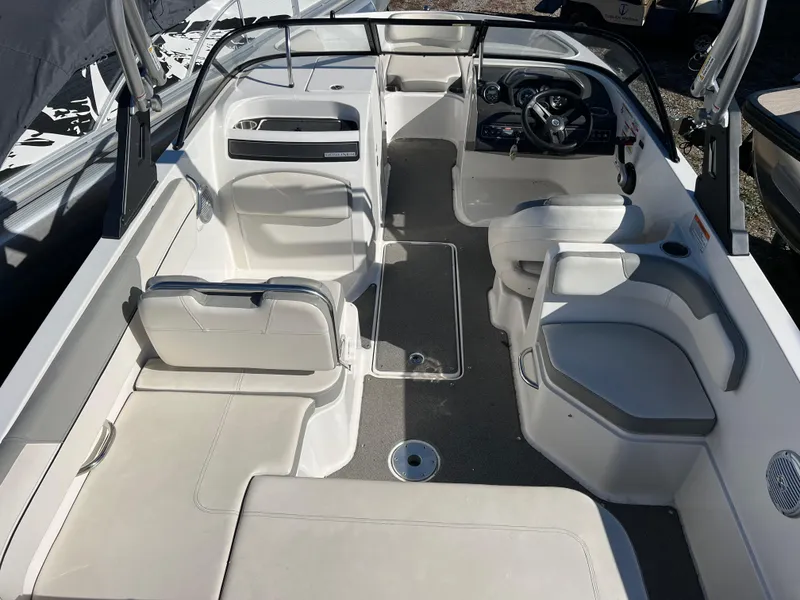 Slide: The Image of 2016 Bayliner VR6 boat interior with seating and steering wheel. - 18