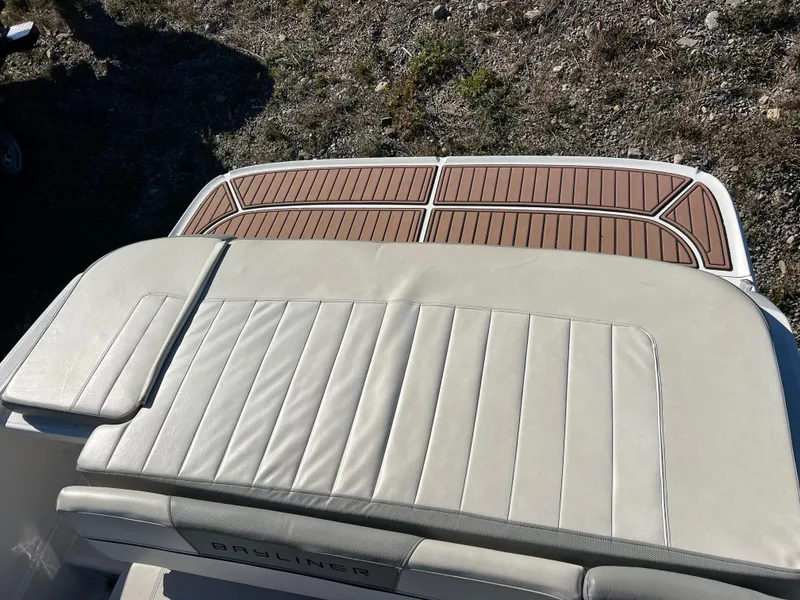 Slide: The Image of 2016 Bayliner VR6 boat with cushioned seating and teak-style deck. - 19