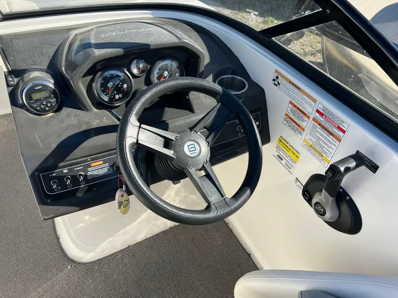 Slide: The Image of 2016 Bayliner VR6 boat dashboard with steering wheel and control panel. - 20