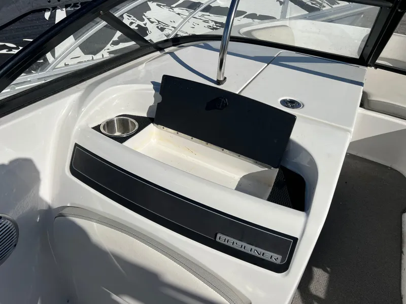 Slide: The Image of 2016 Bayliner VR6 boat interior with cup holders and storage compartment. - 22