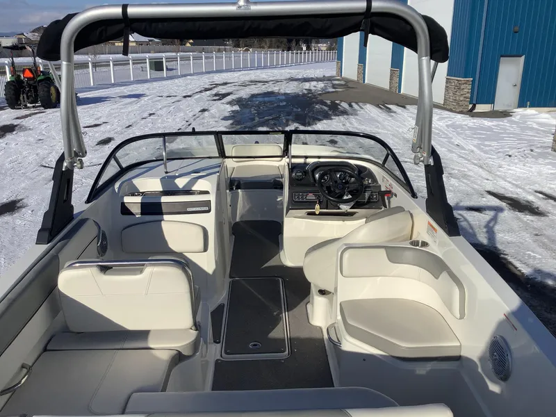 Slide: The Image of 2016 Bayliner VR6 boat interior with seating and steering wheel, parked on snowy ground. - 24