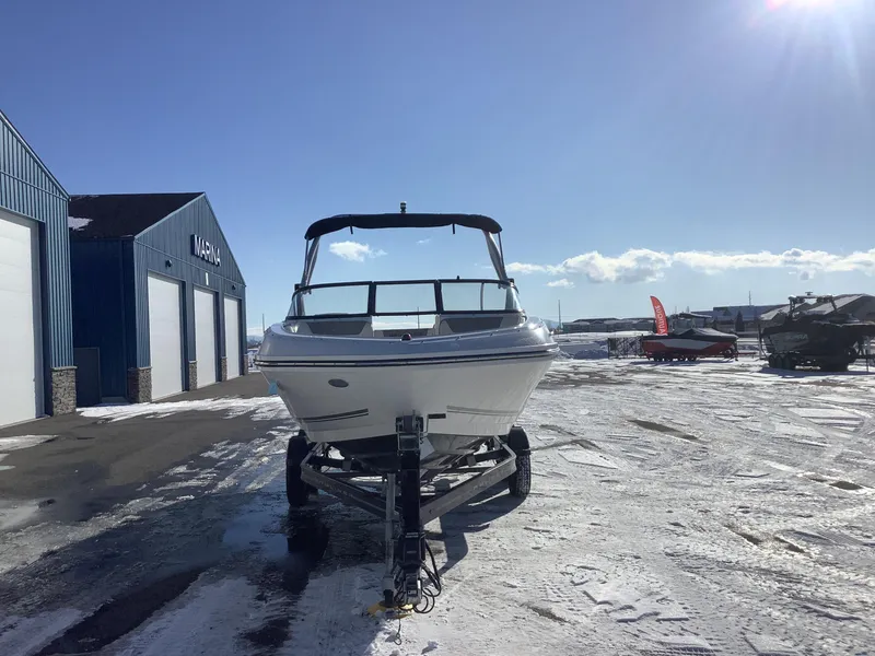 Slide: The Image of 2016 Bayliner VR6 boat on trailer at marina under clear blue sky. - 3