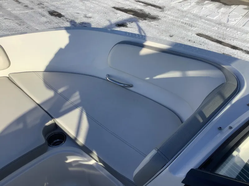 Slide: The Image of 2016 Bayliner VR6 boat interior with white seating and cup holder. - 31