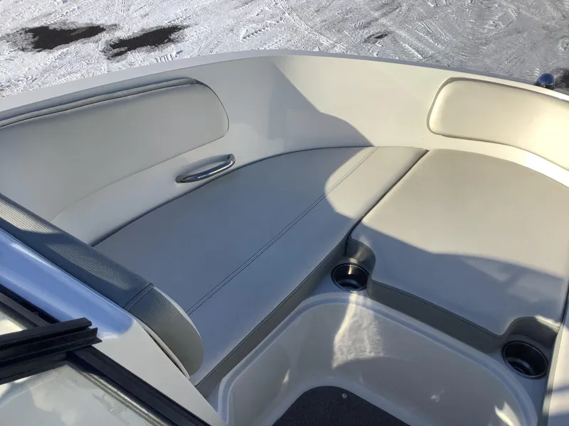 Slide: The Image of 2016 Bayliner VR6 boat interior with cushioned seating and cup holders. - 32